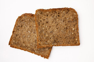 Two slices of wholegrain bread with seeds of sunflower, flax, and sesame. Healthy vegetarian food....