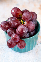 bunch of grapes with water drops in the bowl 