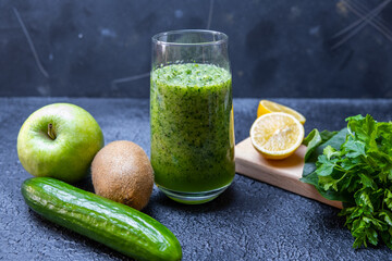 Fresh green organic vegetables. Vegan drink concept. Healthy smoothie on black background.