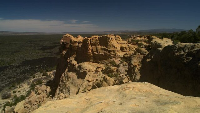 Sandstone Bluffs, El Malpais National Monument in the New Mexico desert is a dramatic landscape made of Dakota Sandstone that contrasts with the dark lava flows below. View of Mount Taylor.
