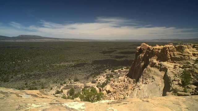Sandstone Bluffs, El Malpais National Monument in the  New Mexico desert is a dramatic landscape made of Dakota Sandstone that contrasts with the dark lava flows farther below. View of Mount Taylor.