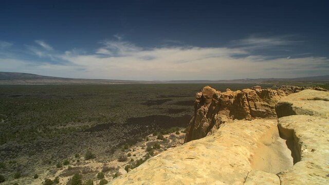 Sandstone Bluffs, in El Malpais National Monument 
New Mexico is a dramatic landscape made of Dakota Sandstone that contrasts with the dark lava flows farther below. View of Mount Taylor.