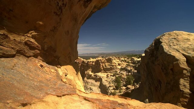 Sandstone Bluffs, El Malpais National Monument in the New Mexico desert is a beautiful landscape made of Dakota Sandstone that contrasts with the dark lava flows below. View of Mount Taylor.
