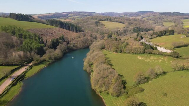 4K flying over hawkridge reservoir, drone moving forward over the water and over a trout fishing boat, 60fps.