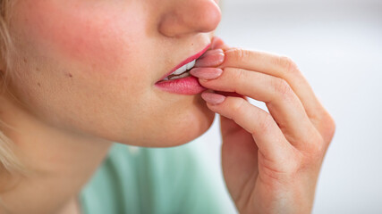 Close-up Of A Businesswoman Biting Her Fingernail. Woman bitting her fingers. Young beautiful businesswoman looking stressed and nervous with hands on mouth biting nails. Anxiety problem