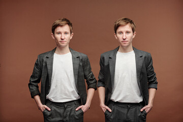 Handsome fashionable twins in smart casual suits