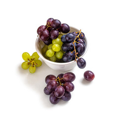 White porcelain cup with clusters of red and white grapes