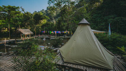 The river runs through the middle of the valley in the forest.