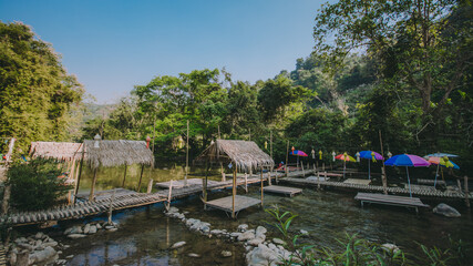 The river runs through the middle of the valley in the forest.