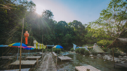 The river runs through the middle of the valley in the forest.