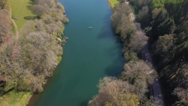4K flying over hawkridge reservoir, drone moving forward over the water and over a trout fishing boat, 60fps.