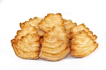 Fan shaped Sfogliatine, an italian puff pastries covered with glaze, on white background.