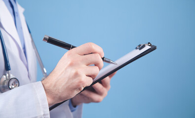 Medical doctor holding pen and clipboard.