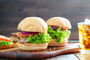 Pork Burger and Bacon  close up on a wooden cutting board , Tomatoes, lettuce, home made.