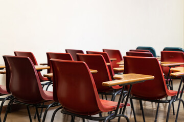old style Red empty plastic chairs in lecture room