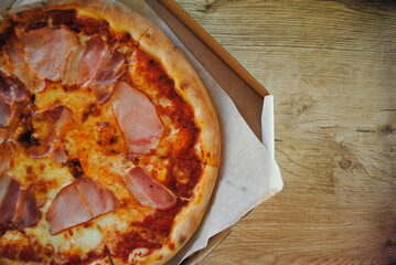 Pizza delivery. Fragrant and hot pizza in a cardboard box. 