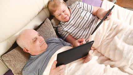 elderly couple with mobile devices