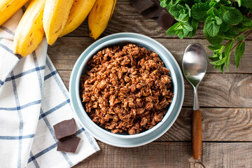 Raw oatmeal porridge with banana and chocolate. Top view