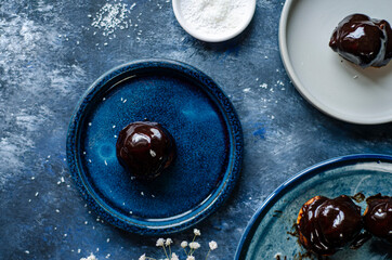 Profiterole, powdered sugar on a blue background