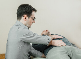 Osteopathic treatment of a patient using CST gentle hands-on technique, central nervous system tension relieve