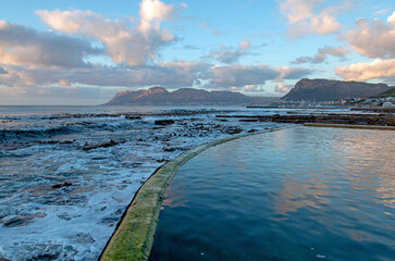 Naklejka premium Sunrise reflections in Dale Brook Tide Swimming Pool in Cape Town South Africa RSA