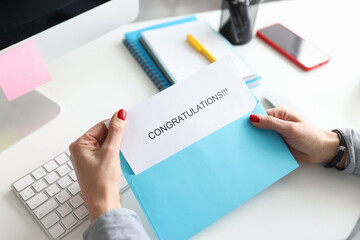 Female hands holding envelope with congratulations closeup