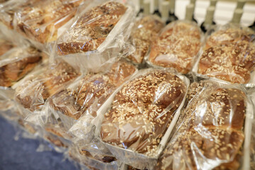 Shallow depth of field (selective focus) image with marble rye breads (Romanian cake named cozonac) in bags ready to eat.