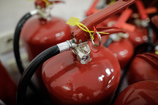 Shallow depth of field (selective focus) image with fire extinguishers inside a building.