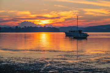 Fototapeta na wymiar Sunrise waterscape with boats and soft colour