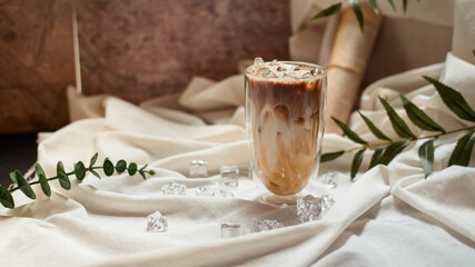 glass of coffee with milk on a white canvas