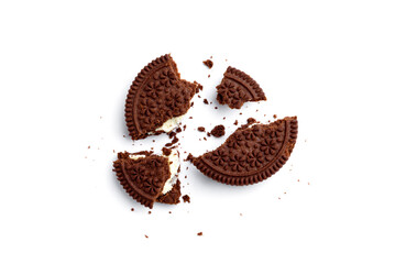Broken chocolate cookies with milk filling isolated on white background. Top view.