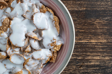 Whole grain glazed flakes with yogurt in plate. Healthy breakfast, whole grain muesli in a bowl