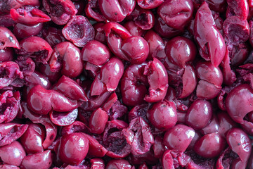 Pitted cherry in alcohol in their own juice in a plate, close up, top view