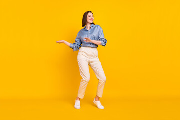 Fototapeta na wymiar Full length photo of attractive young charming woman look empty space dance enjoy isolated on yellow color background