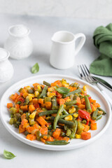 stewed vegetables on a white plate, selective focus