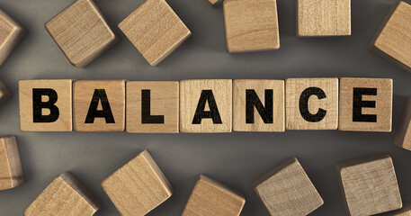 The word BALANCE on small wooden blocks at the desk. Top view