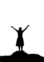 A woman in a skirt dress stands on the top of the mountain and raised her hands up.
