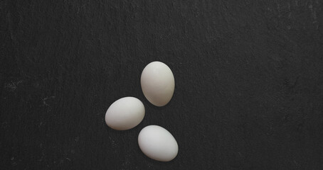 Close up view three chicken eggs isolated on kitchen table. suitable for food design project.