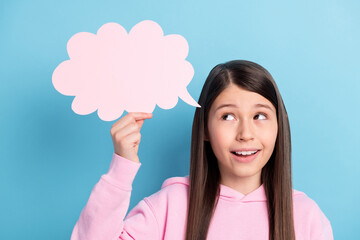 Close-up portrait of attractive cheery minded girl holding copy spacew ad bubble isolated over bright blue color background