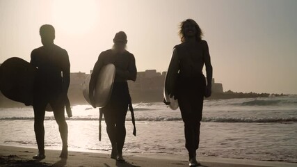 Happy surfers having fun surfing during sunset time - Extreme sport lifestyle and friendship concept - Powered by Adobe