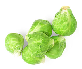 Fototapeta premium Heap of Brussel Sprouts isolated on white background. Fresh raw brussel cabbage, whole and half. Top view .