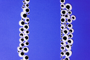 Frames for text from toy eyes on monochrome purple background