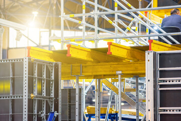 Yellow metal beams on scaffolding props