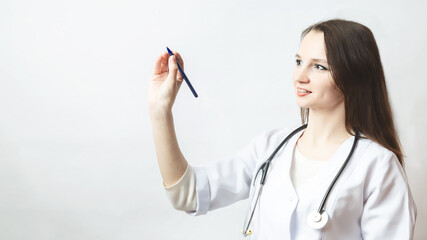 woman doctor writes something in the air with a pen close up
