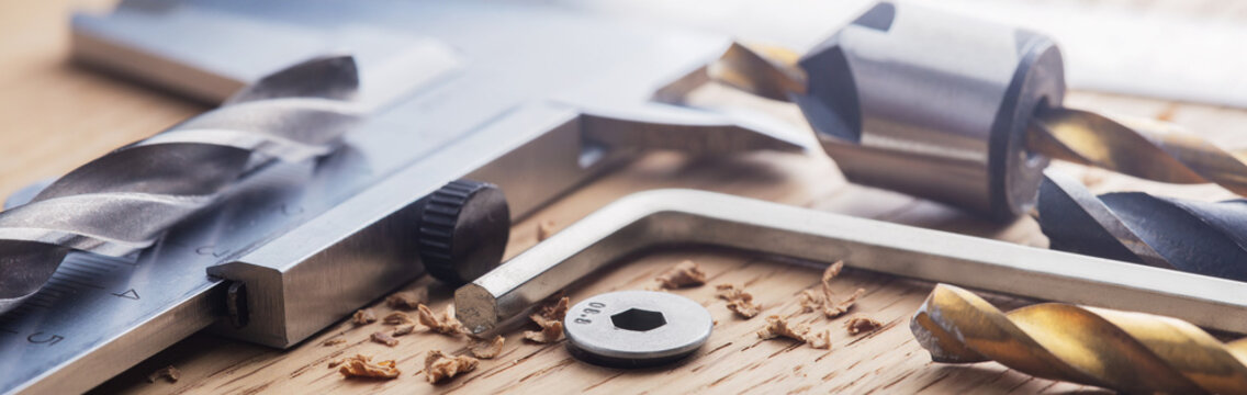 hex bolt screw by hex wrench in wooden oaks plate with with vernier caliper and ruler