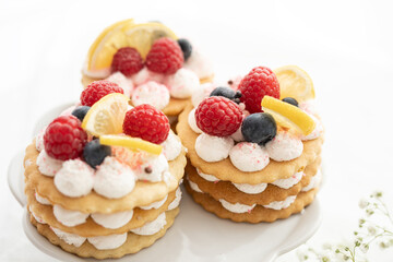 selection of sweet baked cream edible flowers and fruit dessert cakes for mothersday, wedding, birthday, paerty celebration. viola odorata cake. 