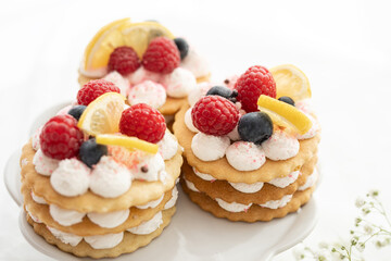 selection of sweet baked cream edible flowers and fruit dessert cakes for mothersday, wedding, birthday, paerty celebration. viola odorata cake. 