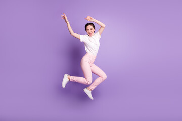 Full body profile side photo of young attractive girl happy positive smile jump up isolated over violet color background