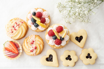 selection of sweet baked cream edible flowers and fruit dessert cakes for mothersday, wedding, birthday, paerty celebration. viola odorata cake. 