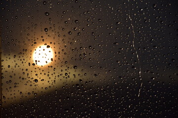 Rain drops on a windows in sunset time